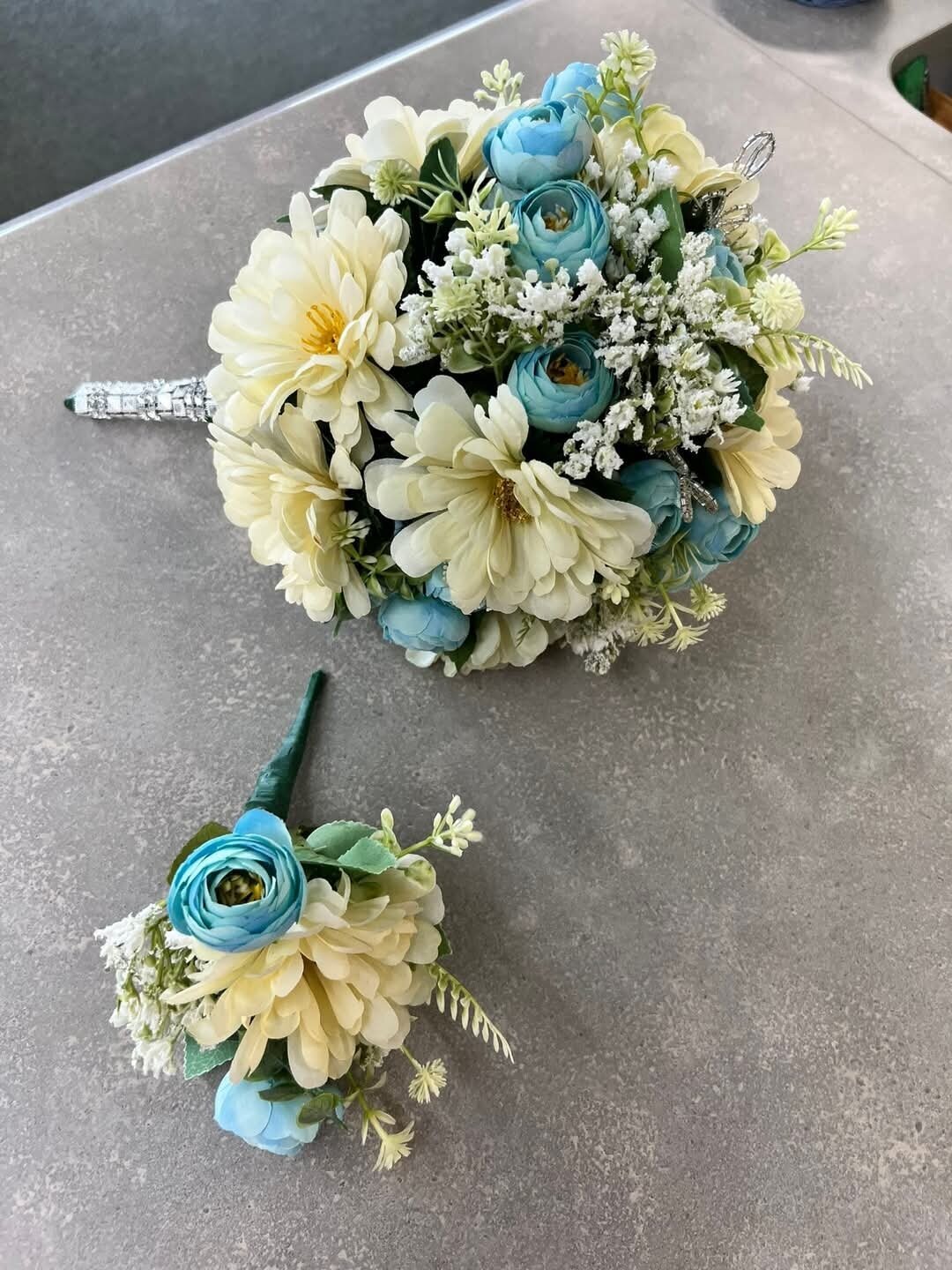 Wedding bouquet and boutonniere in blue and cream